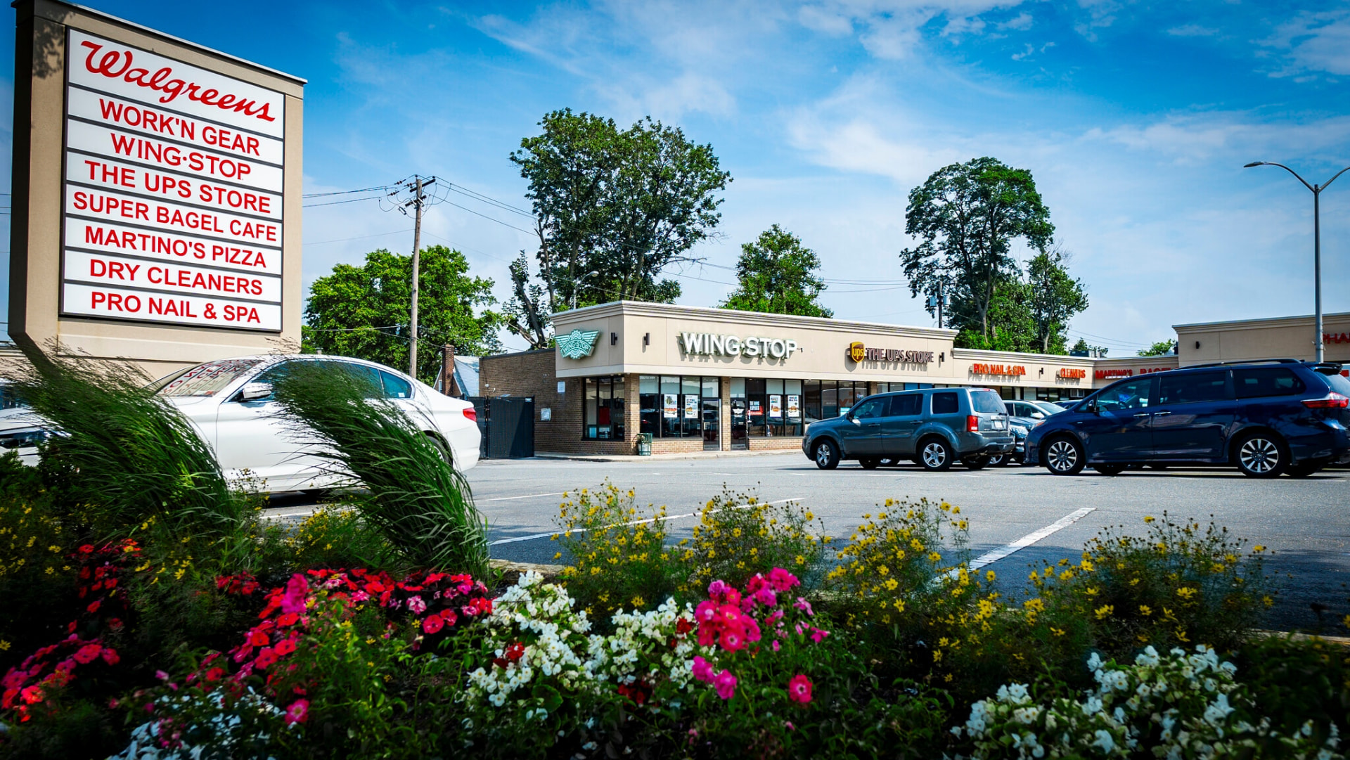 Local shops along Hempstead Turnpike in Elmont, including Wing Stop, The UPS Store, and Martino's Pizza